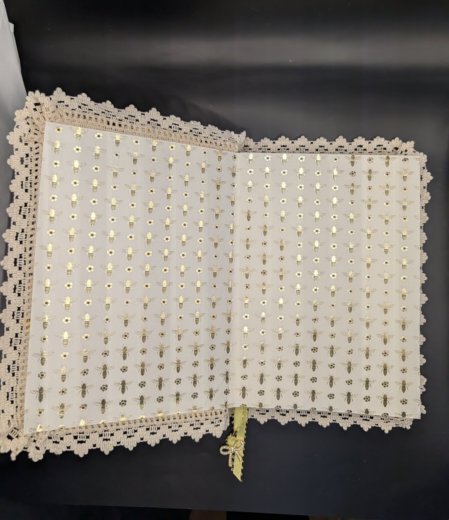 Handmade fabric and lace journal with honeybee pattern for journaling and scrapbooking. Shown inner pages with gold prints and cream cotton lace.