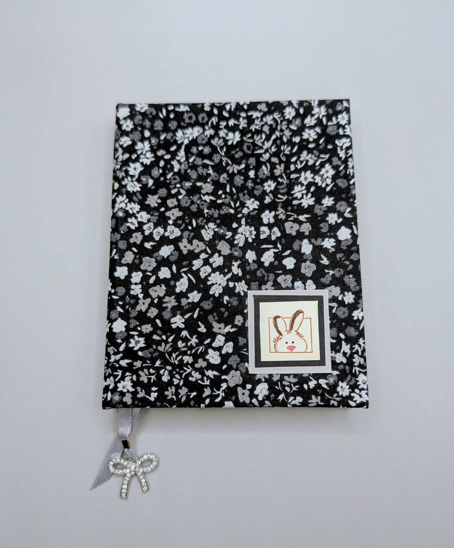 Tiny Black and Gray Flowers on black background with a little bunny head print as embellishment - Handmade Fabric Journal