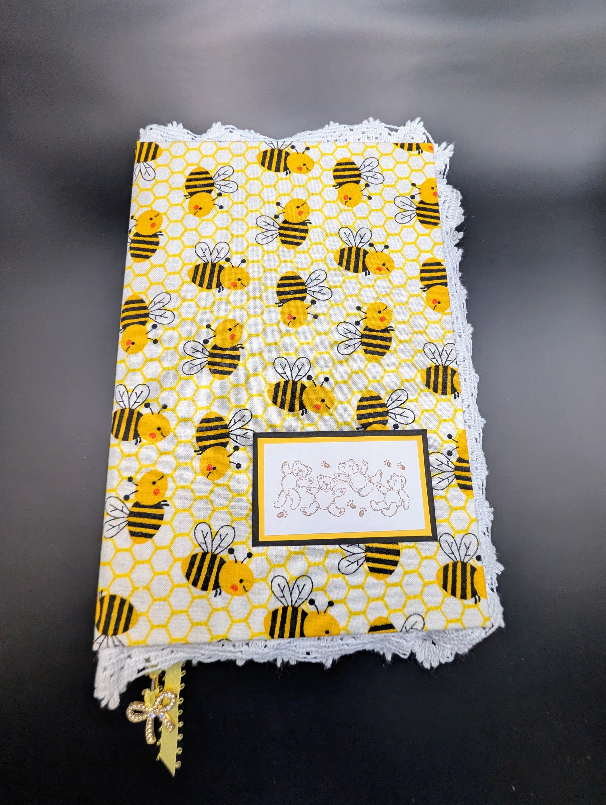 Handmade fabric and lace journal with honeybee pattern for journaling and scrapbooking. Showing front cover with white cotton lace.
