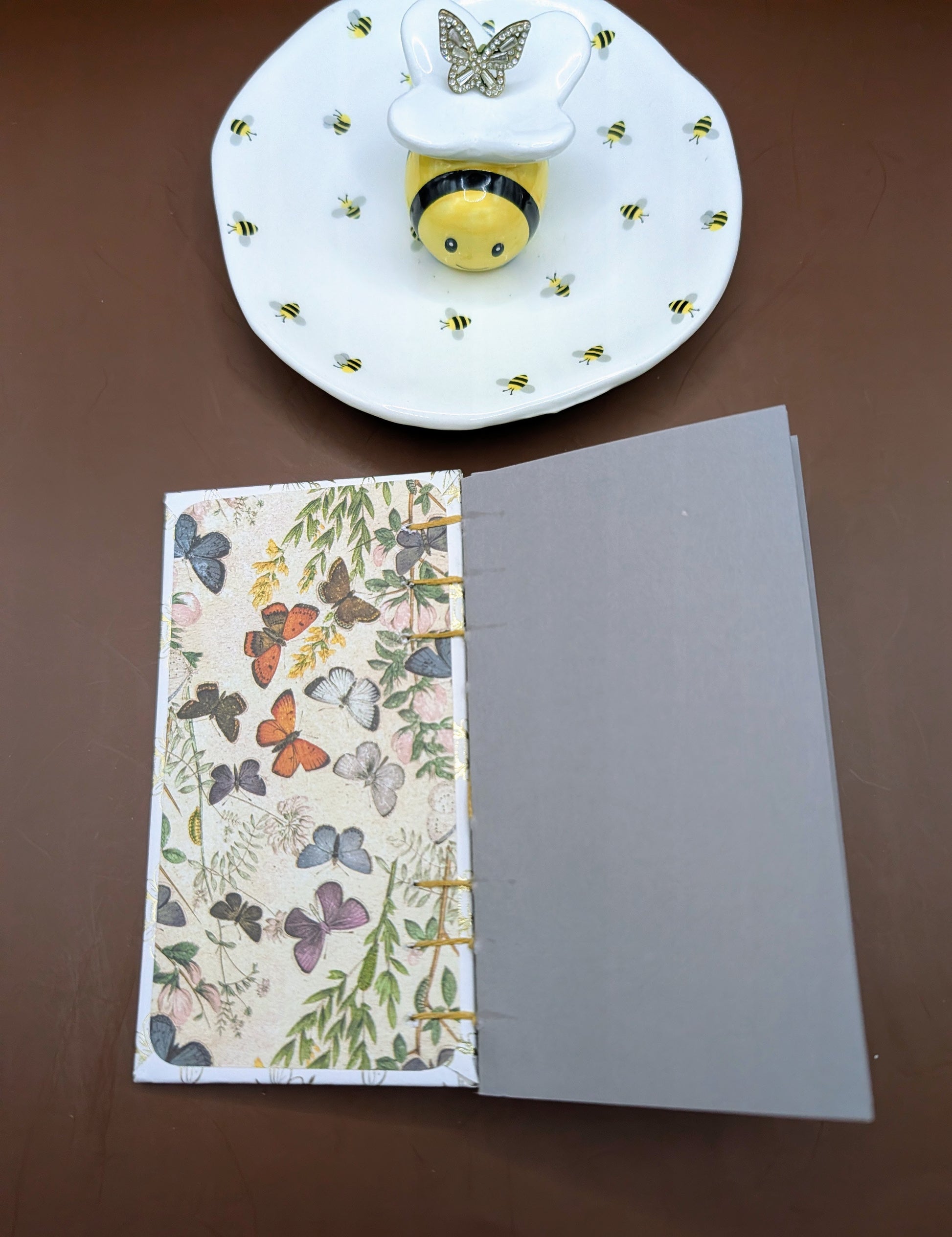 Whimsical handmade 3x5" mini sketchbook with a cute honey bee print. Includes 80 pages of gray cardstock, perfect for sketching, white markers, & journaling. Shown Scrapbooking paper as end paper.